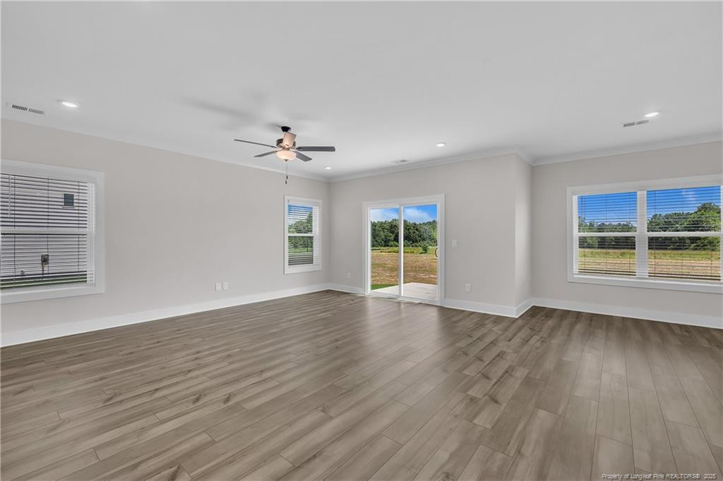 136 Camp Rock Road Lillington, NC 27546 - Photo 9 of 43 a view of an empty room with a window and wooden floor
