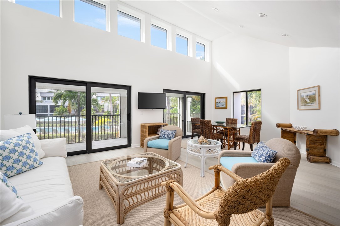 a living room with furniture and a floor to ceiling window
