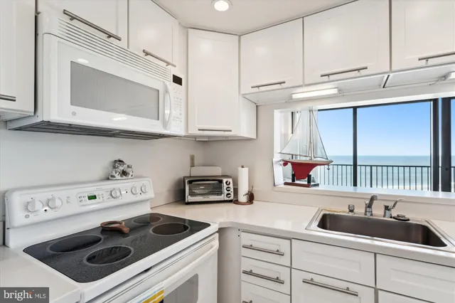 a kitchen with stainless steel appliances a stove a sink and cabinets