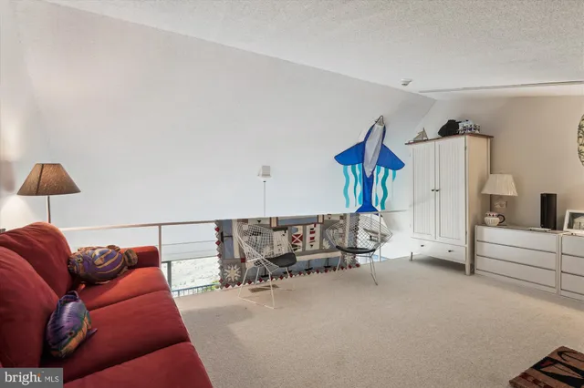 a living room with furniture a flat screen tv and a couch