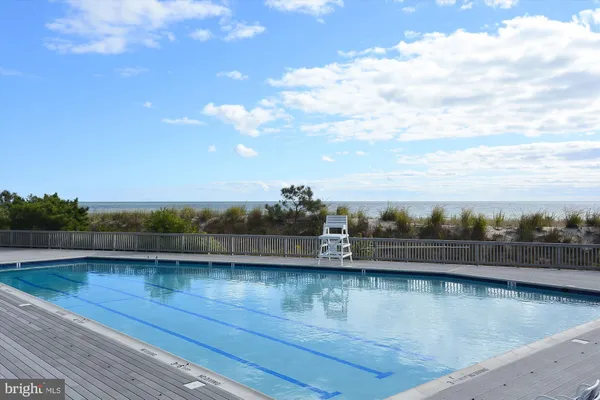 a swimming pool with outdoor seating and city view