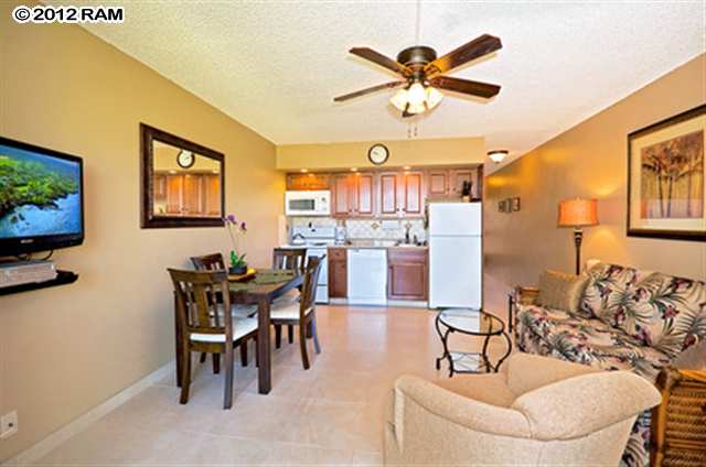 3959 Lower Honoapiilani Road, Unit 305 Lahaina, HI 96761 - Photo 2 of 16 a living room with furniture and a flat screen tv