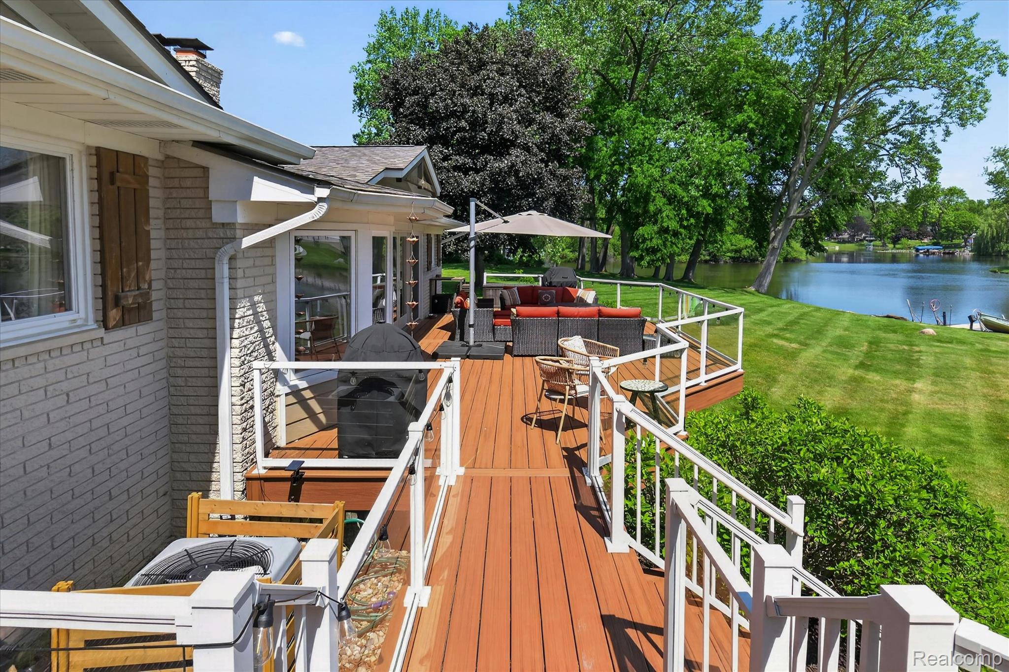 3860 East Commerce Road Commerce Township, MI 48382 - Photo 4 of 72 Expansive outdoor deck featuring wood-finish flooring and white railings with glass panels