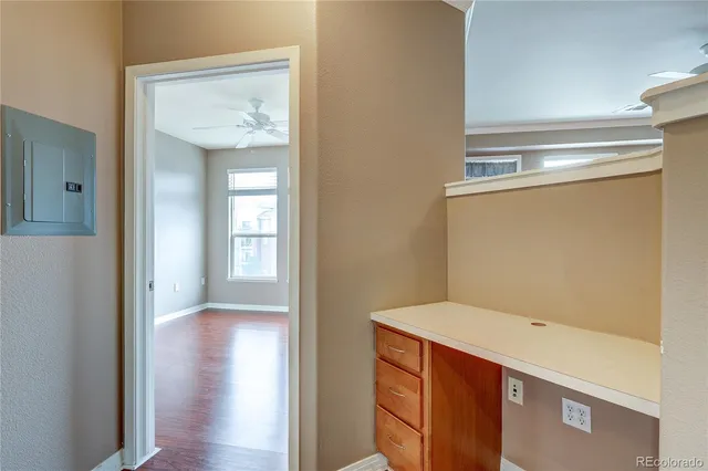 a view of an empty room with wooden floor
