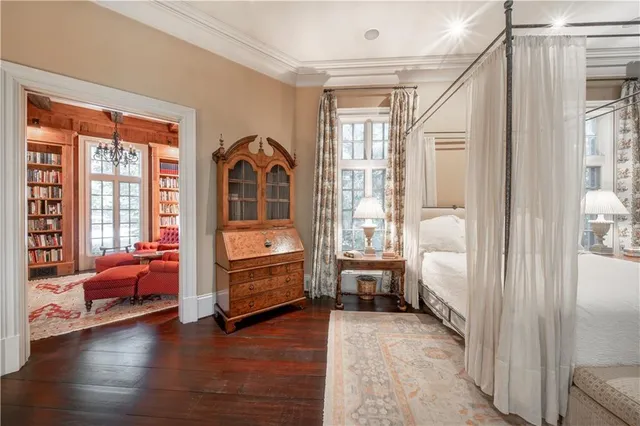 a living room with lots of furniture and a book shelf