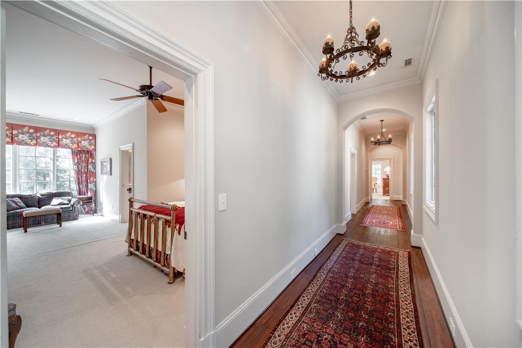 1955 Alec Mountain Road Clarkesville, GA 30523 - Photo 44 of 110 a view of a hallway to a livingroom with wooden floor and a chandelier