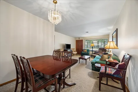 a view of a dining room with furniture and window