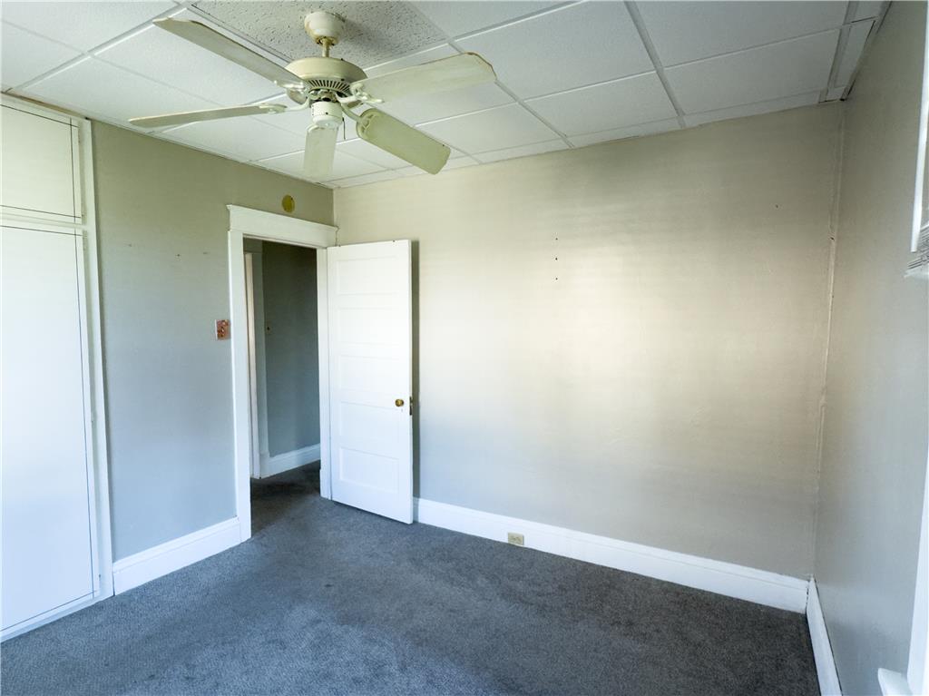 870 Chestnut Street Coplay, PA 18037 - Photo 9 of 24 A comfortable bedroom features carpet flooring and a ceiling fan, offering a tranquil retreat.