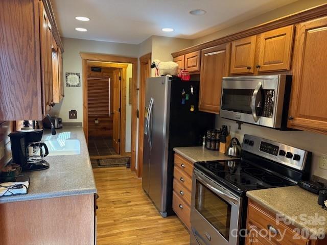 399 Bent Tree Road Maggie Valley, NC 28751 - Photo 22 of 48 a kitchen with stainless steel appliances granite countertop a stove a sink and a refrigerator