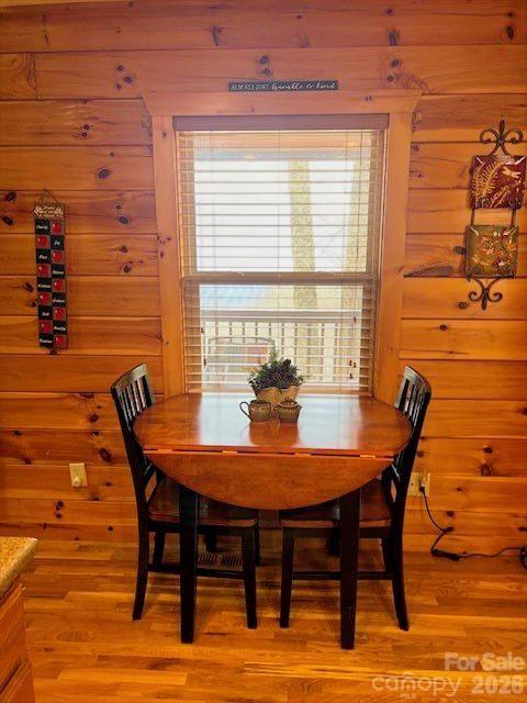399 Bent Tree Road Maggie Valley, NC 28751 - Photo 24 of 48 a view of a dining room with furniture and wooden floor