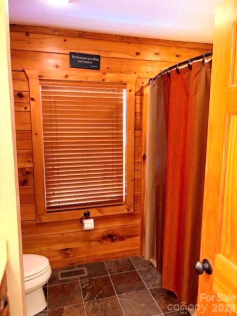 399 Bent Tree Road Maggie Valley, NC 28751 - Photo 36 of 48 a view of a bathroom with a shower and a toilet