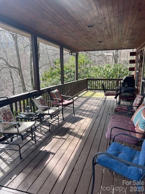 399 Bent Tree Road Maggie Valley, NC 28751 - Photo 7 of 48 a view of a balcony with chairs and wooden floor