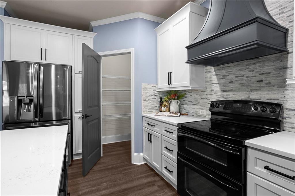 506 Olympic Way Acworth, GA 30102 - Photo 18 of 73 a kitchen with a refrigerator stove and cabinets