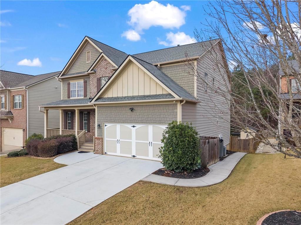 506 Olympic Way Acworth, GA 30102 - Photo 2 of 73 a front view of a house with a yard and potted plants