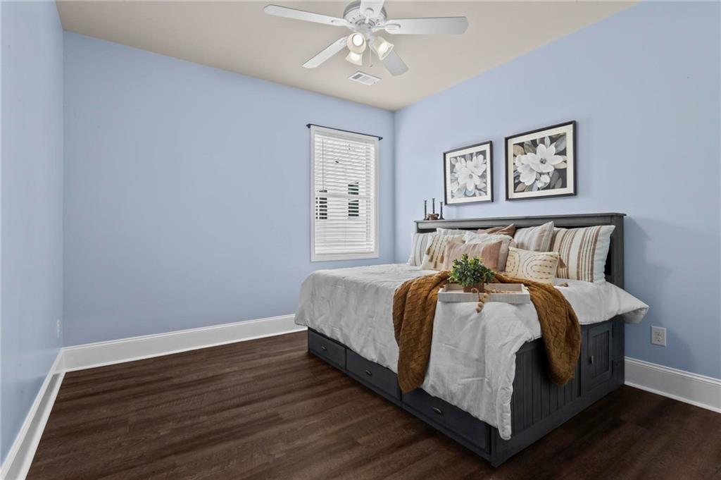506 Olympic Way Acworth, GA 30102 - Photo 25 of 73 a large bed sitting in a bedroom next to a chandelier