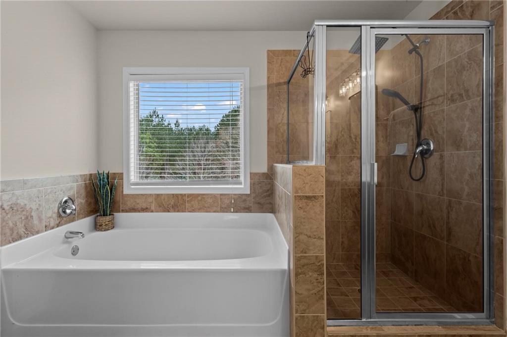 506 Olympic Way Acworth, GA 30102 - Photo 33 of 73 a bathroom with a bathtub and a shower