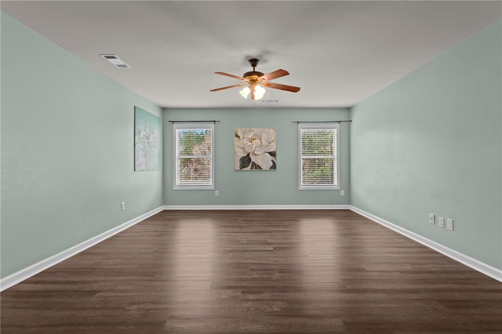 506 Olympic Way Acworth, GA 30102 - Photo 36 of 73 a view of an empty room with window and wooden floor