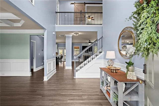 a view of an entryway with wooden floor and stairs
