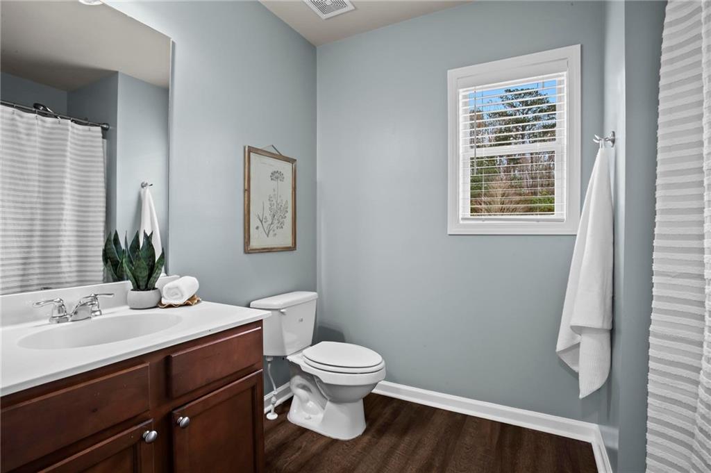 506 Olympic Way Acworth, GA 30102 - Photo 41 of 73 a bathroom with a toilet a sink and a mirror