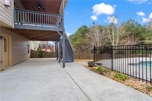a swimming pool with some trees in the background