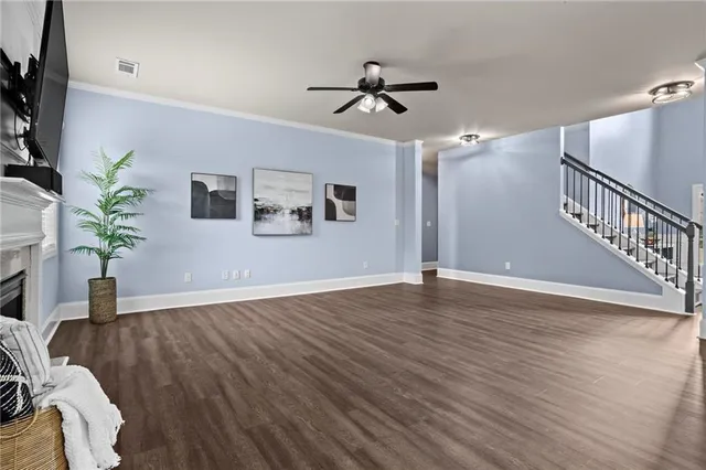 a kitchen with a table a refrigerator and wooden floor
