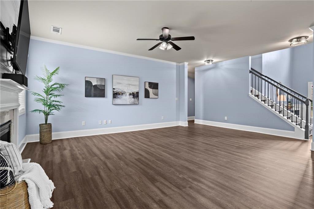 506 Olympic Way Acworth, GA 30102 - Photo 9 of 73 a view of a livingroom with wooden floor and a potted plant