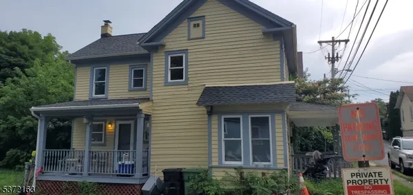a front view of a house with plants