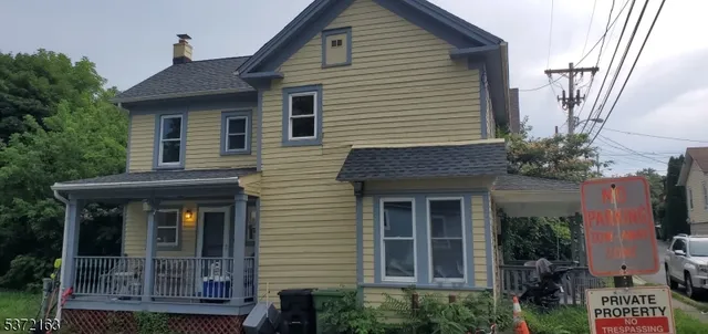 a front view of a house with plants
