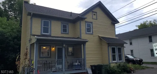 a front view of a house with plants
