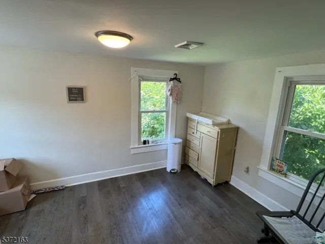 a view of room with window and wooden floor