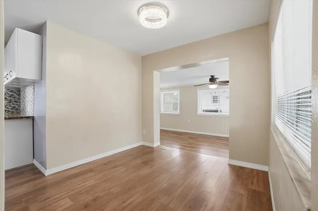 a kitchen with granite countertop white cabinets stainless steel appliances and sink