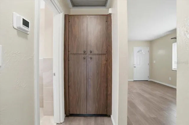 a view of empty room with wooden floor