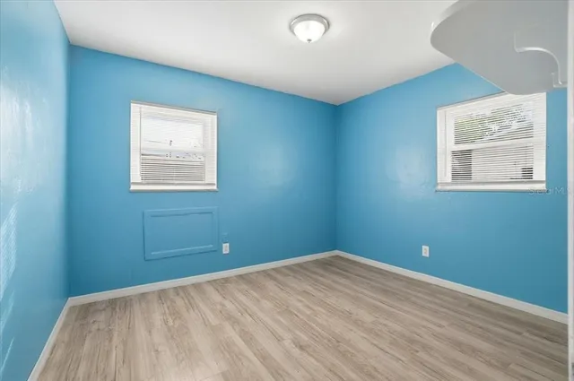 a view of an empty room with wooden floor