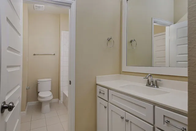 a view of bathroom with a sink toilet and a mirror