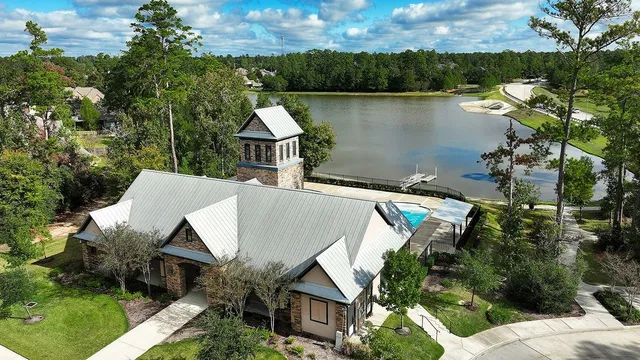 an aerial view of house with yard and lake
