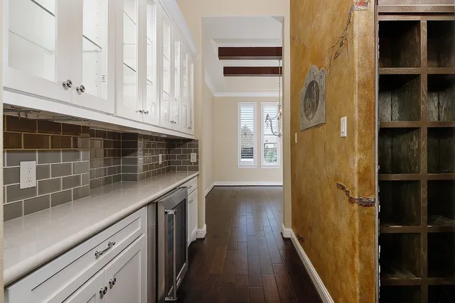 a kitchen with cabinets and wooden floor