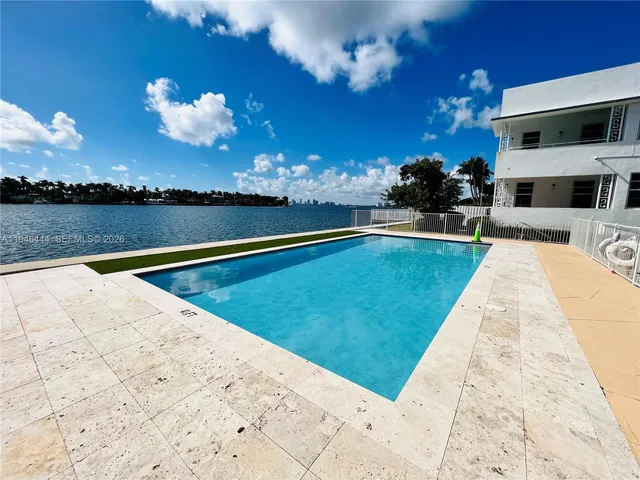 a view of a swimming pool with an outdoor seating