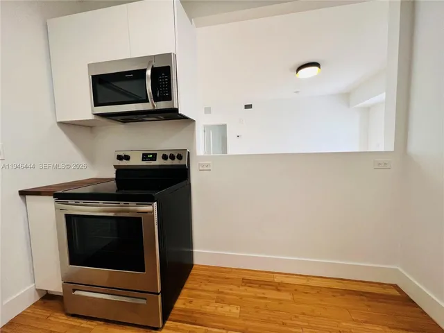 a kitchen with a stove and a microwave