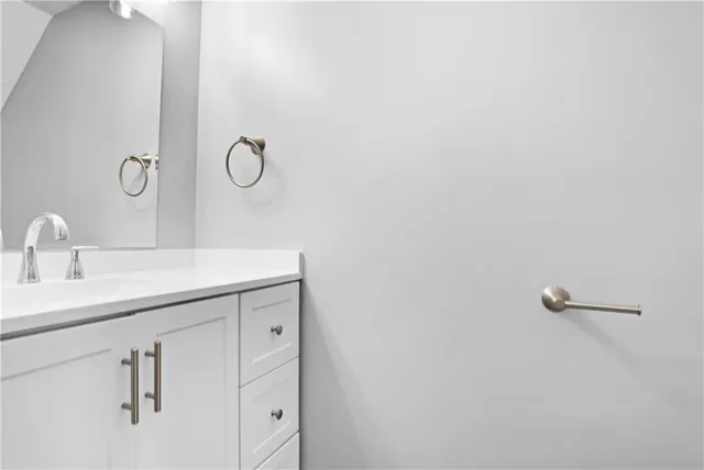 a bathroom with a sink and mirror