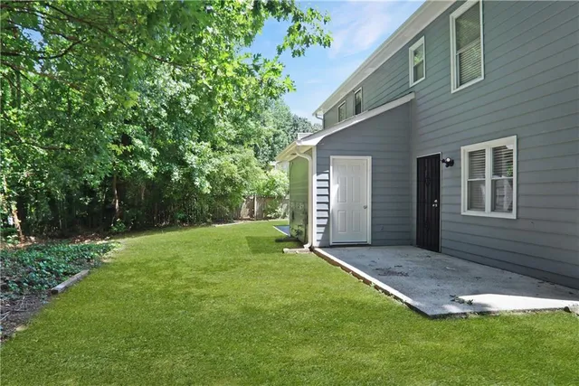 a view of a backyard with a large tree