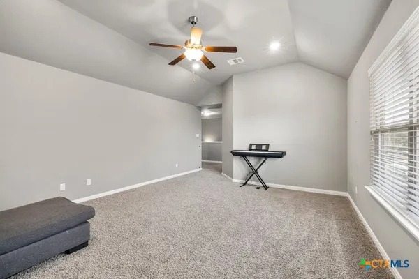 a view of a livingroom with a ceiling fan and window