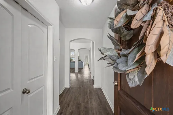 a view of entryway and hall with wooden floor