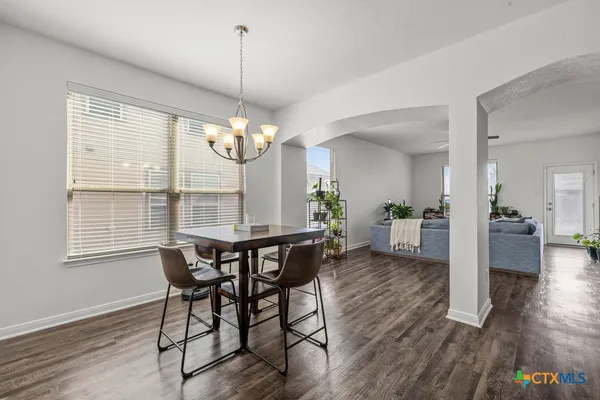 a view of a dining room with furniture wooden floor and chandelier