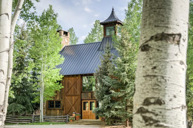 a living room with furniture fireplace and a large window