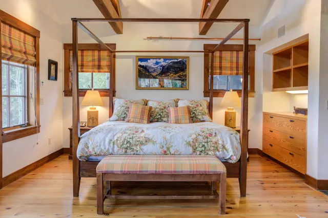 a view of a balcony with chairs and a potted plant