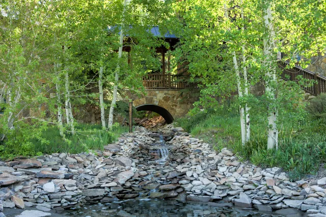 a bedroom with a bed a mirror and a window