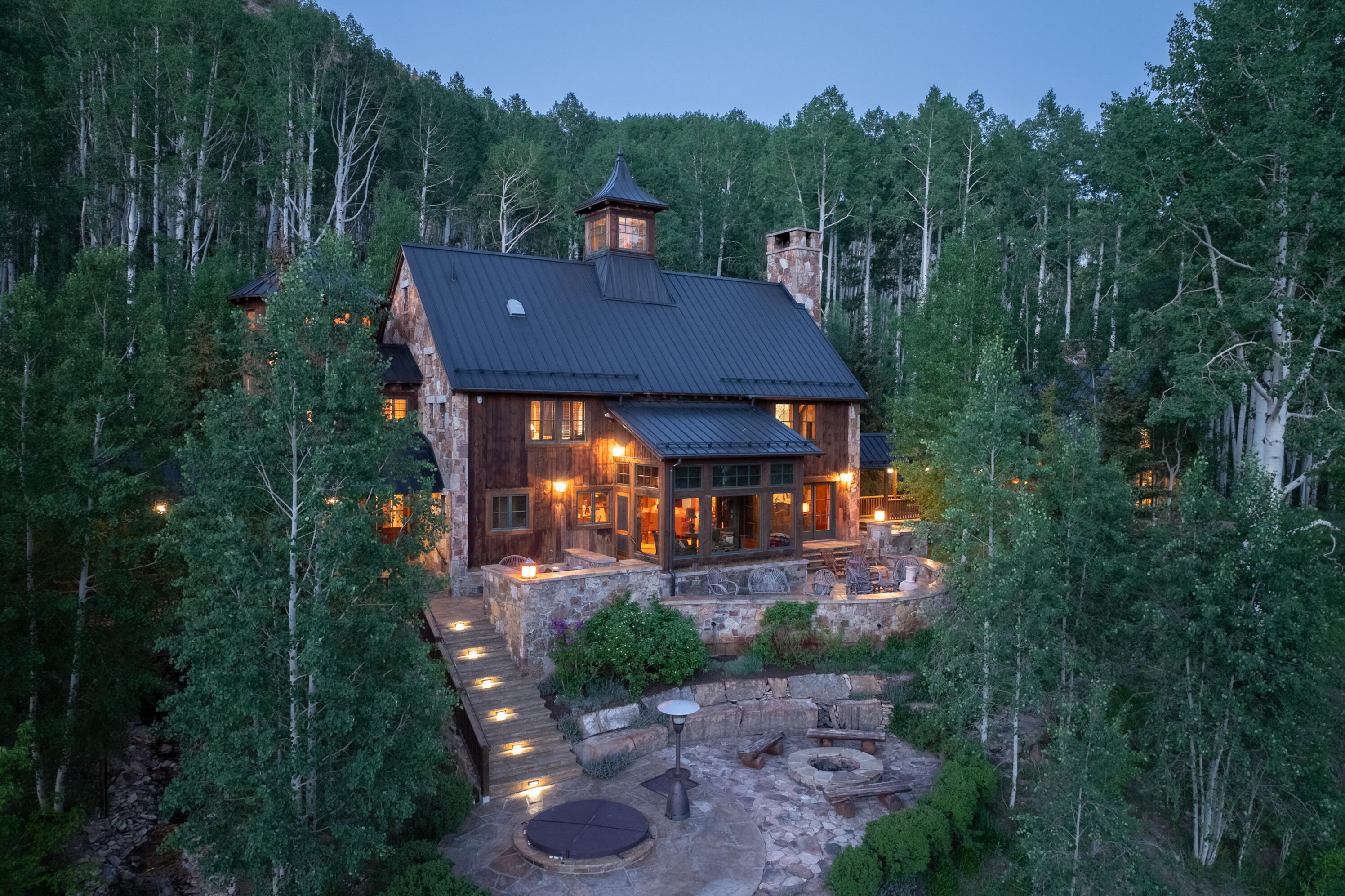 6131 Last Dollar Road Telluride, CO 81435 - Photo 83 of 86 a view of a patio with table and chairs potted plants and large tree