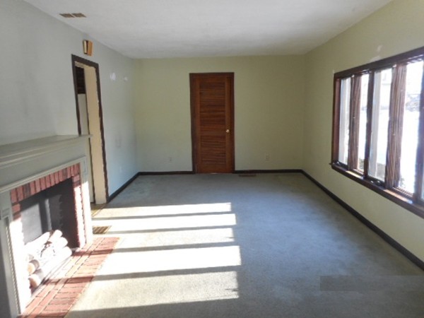 211 Davis Street Springfield, MA 01104 - Photo 5 of 13 a view of a livingroom with wooden floor and staircase