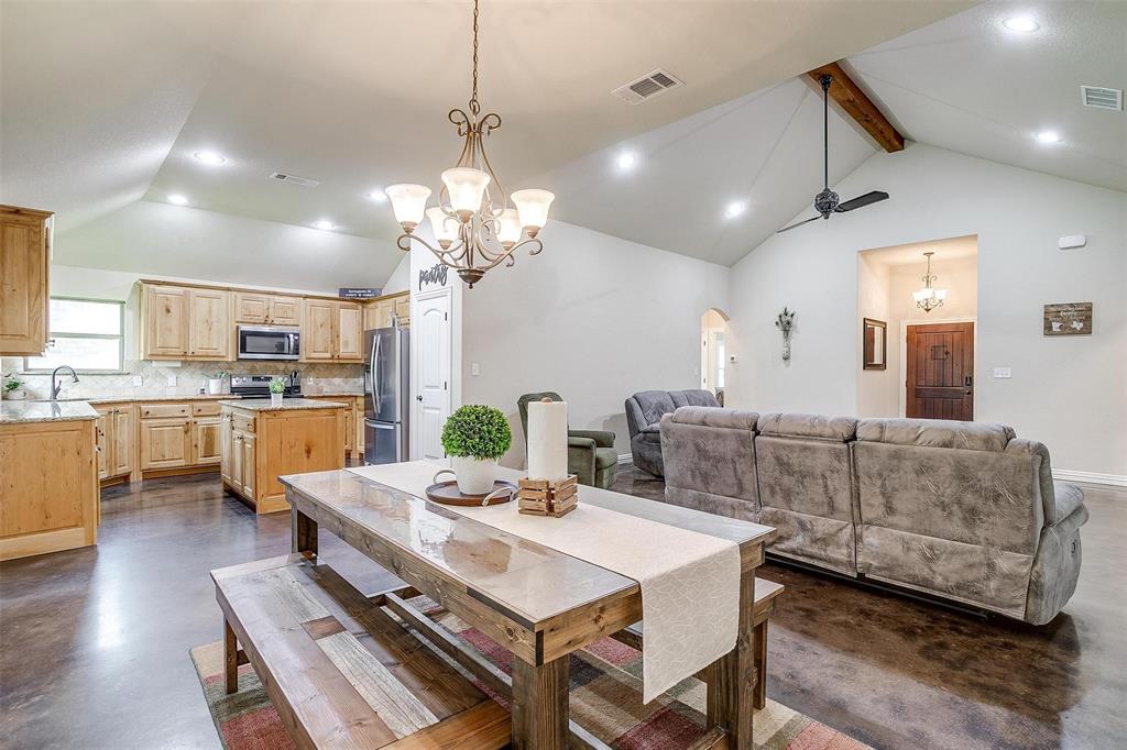 505 N Avenue East Springtown, TX 76082 - Photo 11 of 27 a view of a dining room and livingroom with furniture wooden floor a chandelier