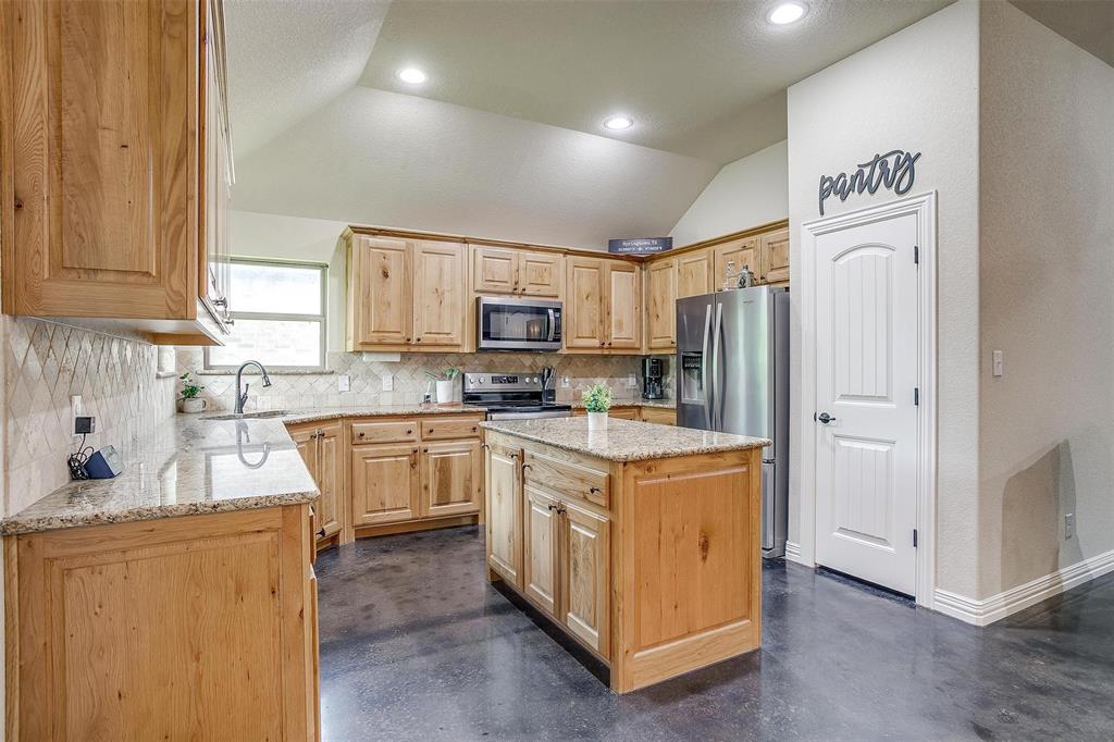 505 N Avenue East Springtown, TX 76082 - Photo 12 of 27 a kitchen with stainless steel appliances granite countertop a refrigerator sink and cabinets